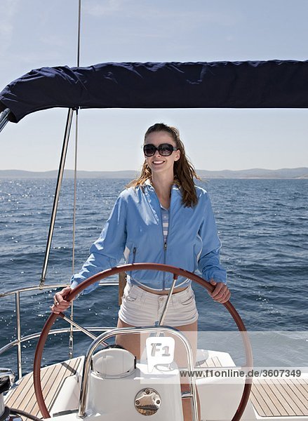 Woman steering yacht