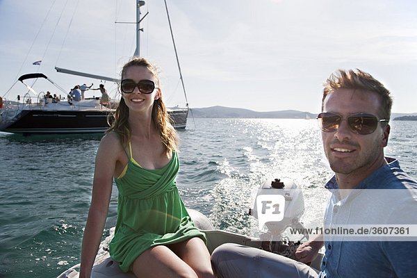 Man and woman in yacht dinghy
