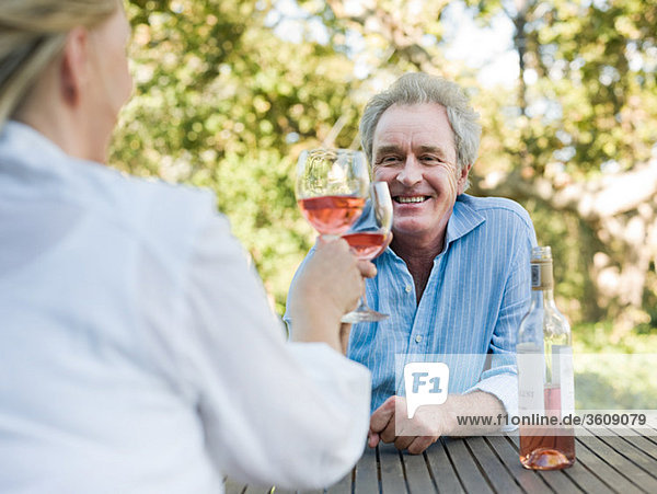 Couple toasting with wine outdoors