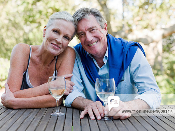 Mature couple outdoors with wine