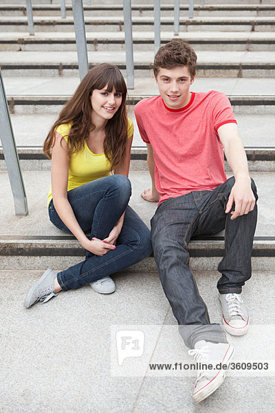 Young couple sitting on steps