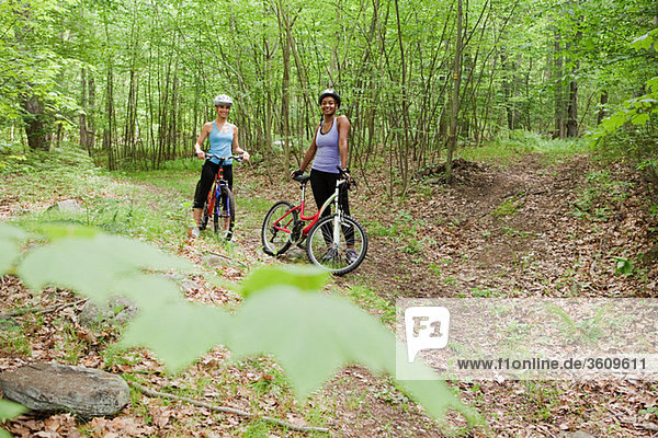 Two female cyclists in forest