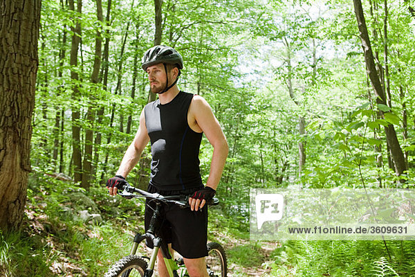 Male cyclist in forest