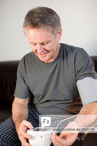 Mann mit Blutdruckmessgerät