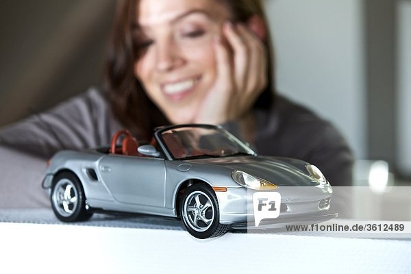Woman looking at toy car