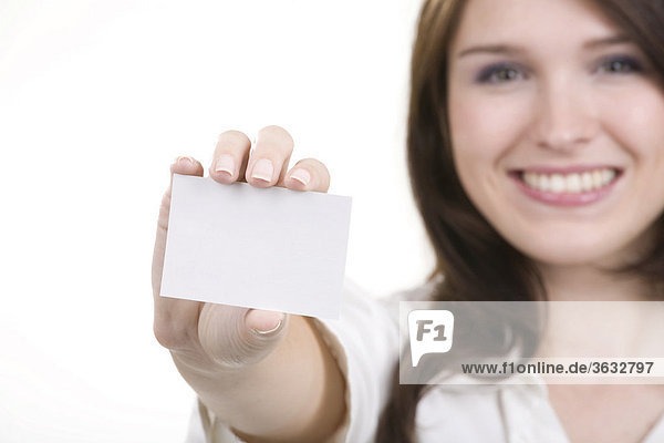 Smiling young woman with a business card