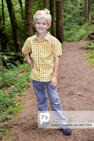Boy  5 years old  on a forest path
