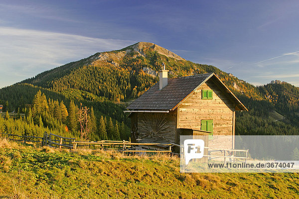 Wooden huts on the Turnauer alp at sunset Styria Austria