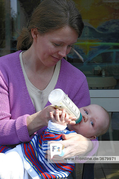 Baby drinks milk bottle