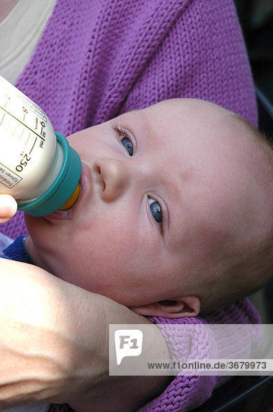 Baby drinks milk bottle