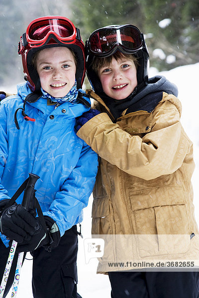 Children on skis hugging