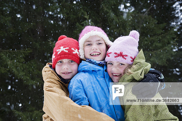 Children hugging in the snow