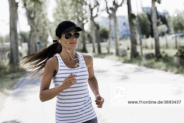 Woman jogging on a sunny street