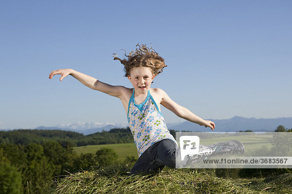 Girl jumping in grass