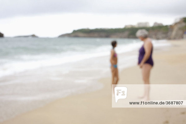 A mother and daughter at the beach  defocused