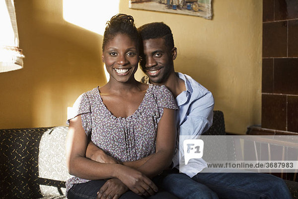 A young couple relaxing on a couch  portrait
