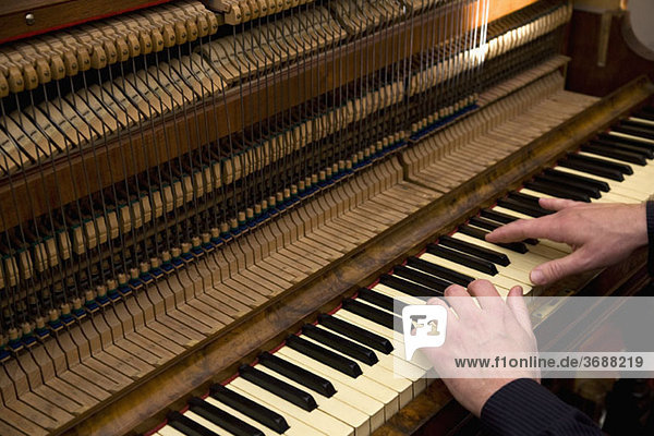 A man playing an organ  close up of hands