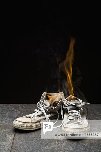 A pair of canvas shoes on fire
