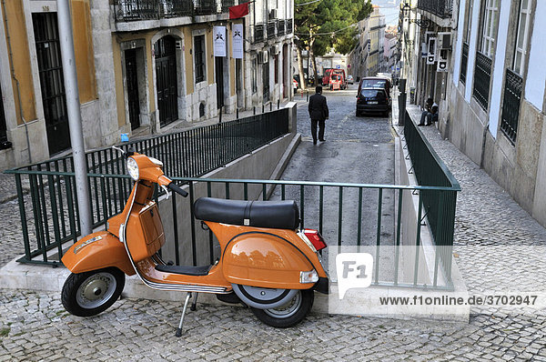 Orange Vespa leaning on a railing  Chiado district of Lisbon  Portugal  Europe