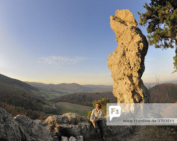 Woman in front of the Arnstein rock spire at sunset  Triestingtal valley  Lower Austria  Austria  Europe