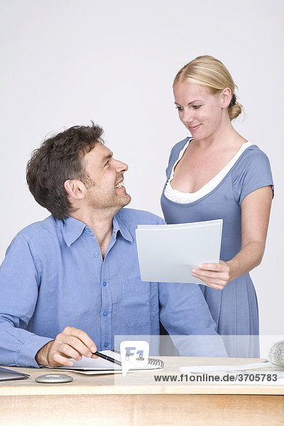 Man and woman  colleagues at office work