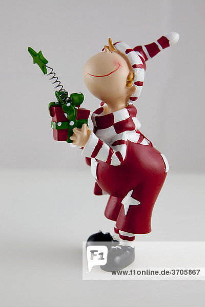 Young Santa Claus with gift  ceramic figurine