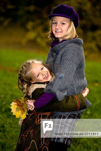 Two girls in a park in autumn