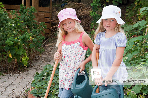 Girls gardening in vegetable garden