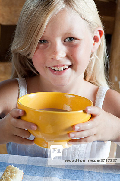Girl with hot drink in bowl