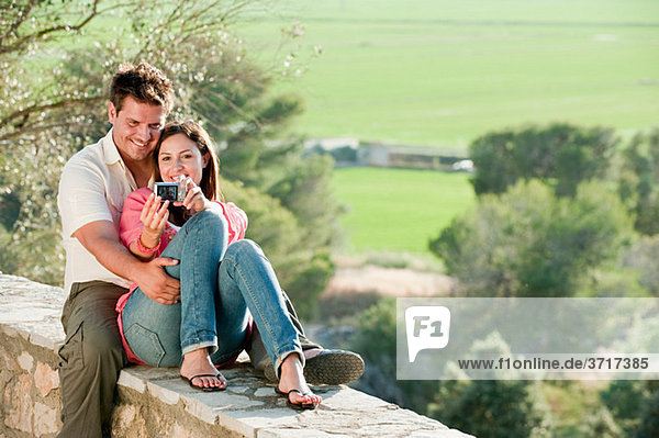 Young couple photographing themselves