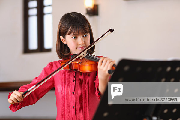 A Young Girl Playing The Violin