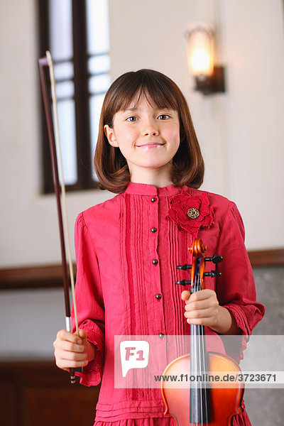 A Young Girl Playing The Violin