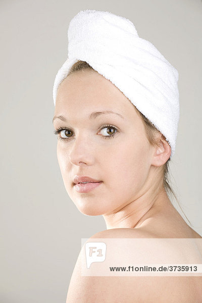 Young woman  towel wrapped around her head