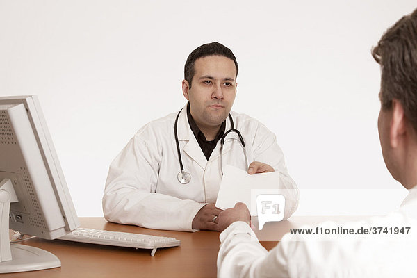 Doctor handing results over to his patient
