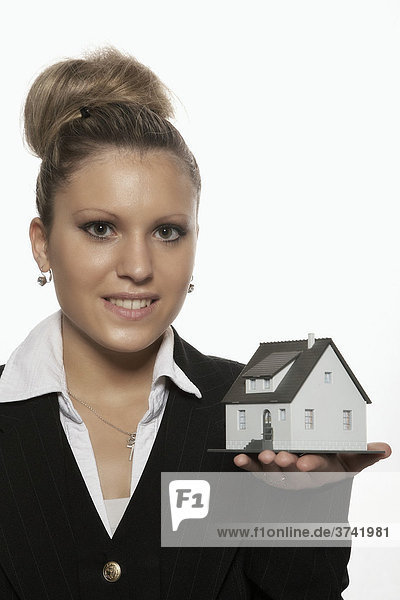 Businesswoman presenting a model house