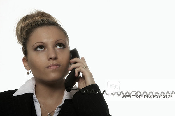 Geschäftsfrau mit Telefonhörer in der Hand