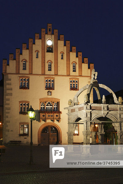 Well outside City Hall at the market square at night  Hammelburg  Rhoen  Lower Franconia  Bavaria  Germany  Europe