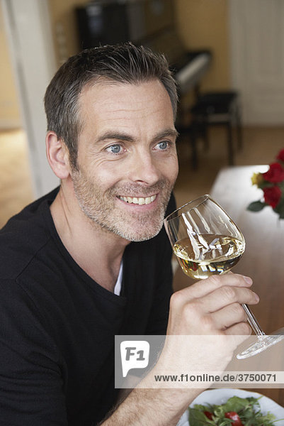 Man sipping on white wine