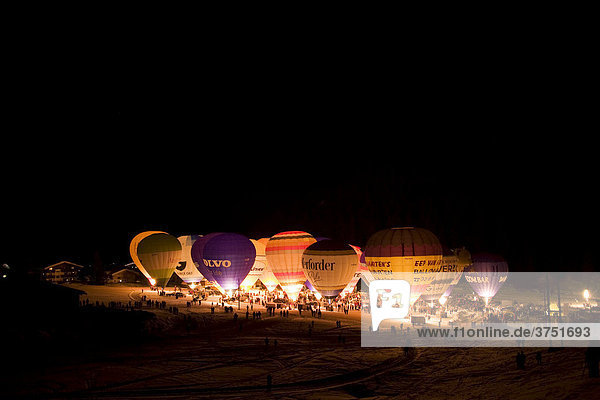 Hot air balloons lit up against a dark night sky  Filzmoos  Salzburg  Austria  Europe