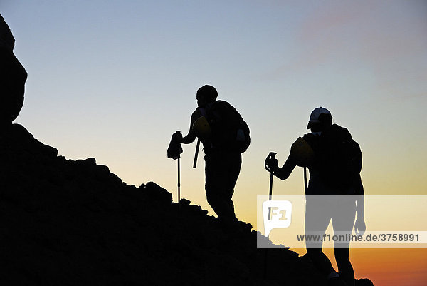 Two hikers in twilight silhouetted as they walk up the active volcano on Stromboli Island  Aeolian Islands  Southern Italy