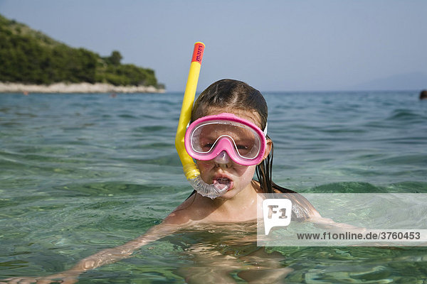 Little girl wearing a diving mask and snorkel  Croatia  Europe
