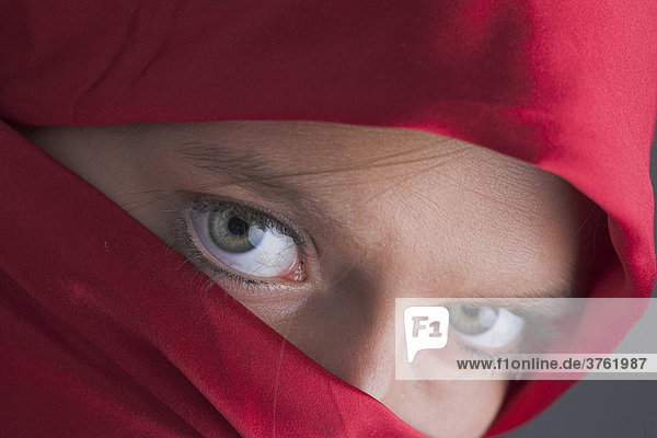 Veiled  young woman with sharp eyes