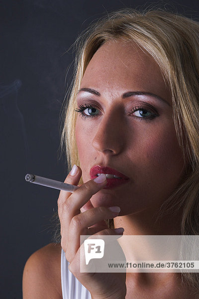 Woman is smoking a cigarette