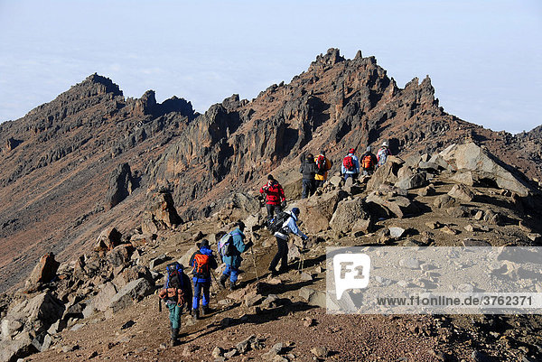 Group of mountaineers in rocky mountain scenery near Austrian Hut below Point Lenana (4985 m) Mount Kenya National Park Kenya