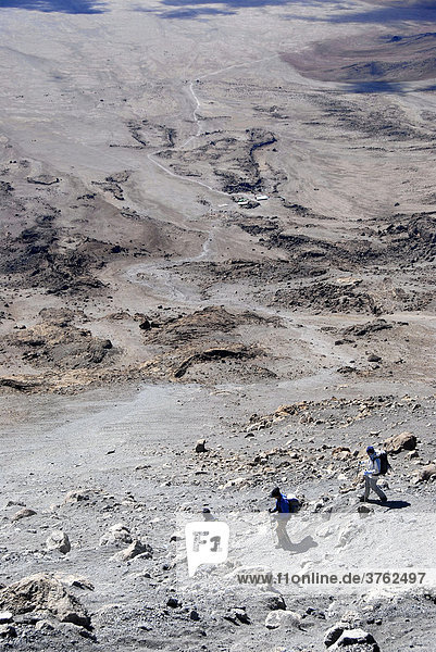 Group of mountaineers at dusty descent to Kibo Hut Marangu Route Kilimanjaro Tanzania