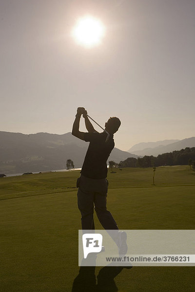 Golf player at a shot  Mondsee  Salzburg  Austria