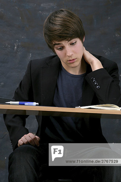 Young man sitting at a desk  learning concentrated