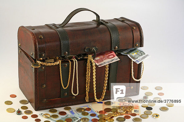 Treasure chest filled with jewellery  coins and banknotes