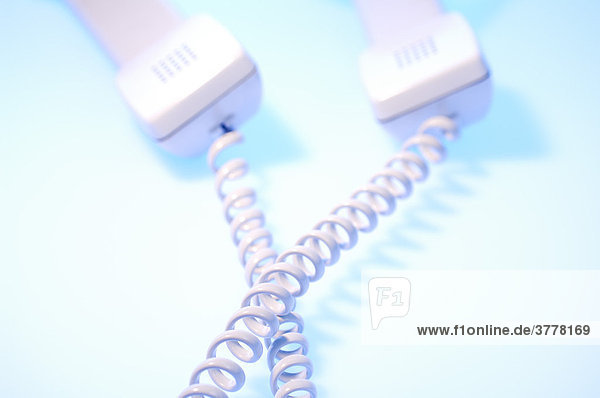 Two telephone receivers with cables