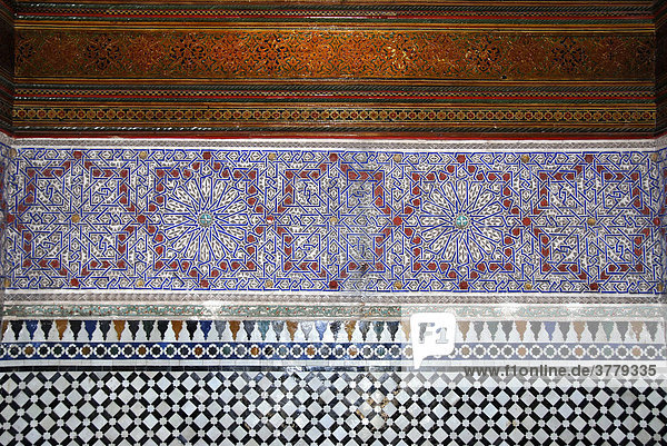 Fine paintings at wooden ceiling with faience glazed tiles Palais de la Bahia Marrakech Morocco